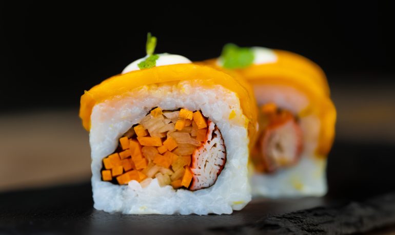 Mango Dezato sushi roll with mango slices, crab sticks, cucumber, carrot, sticky rice, and coconut milk at Sushi Yaki Uttara